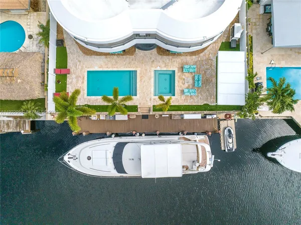 a view of a house with backyard porch and sitting area