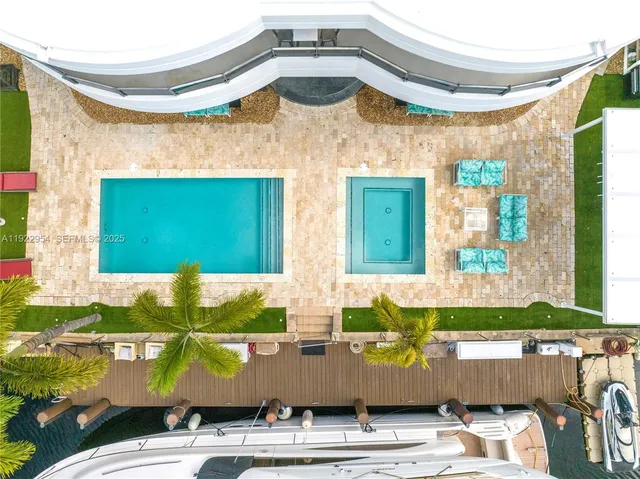 a living room with furniture a flat screen tv and a floor to ceiling window