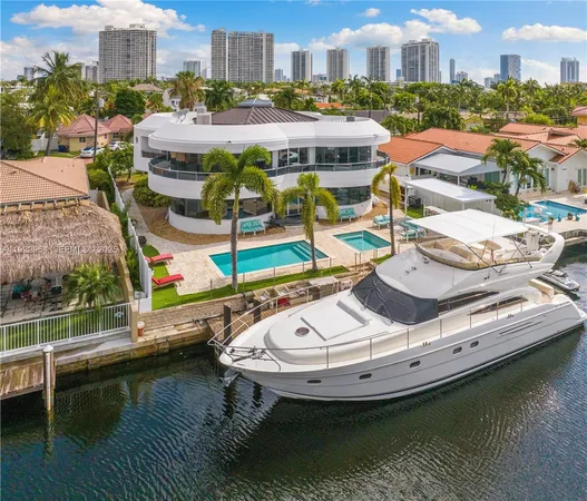 a living room with furniture a flat screen tv and a floor to ceiling window