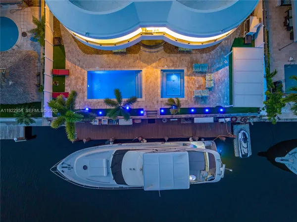 a view of a house with pool and chairs