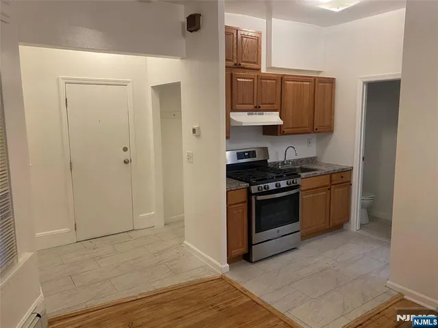 a kitchen with stainless steel appliances a stove and a refrigerator