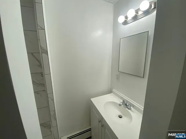 a bathroom with a sink and mirror