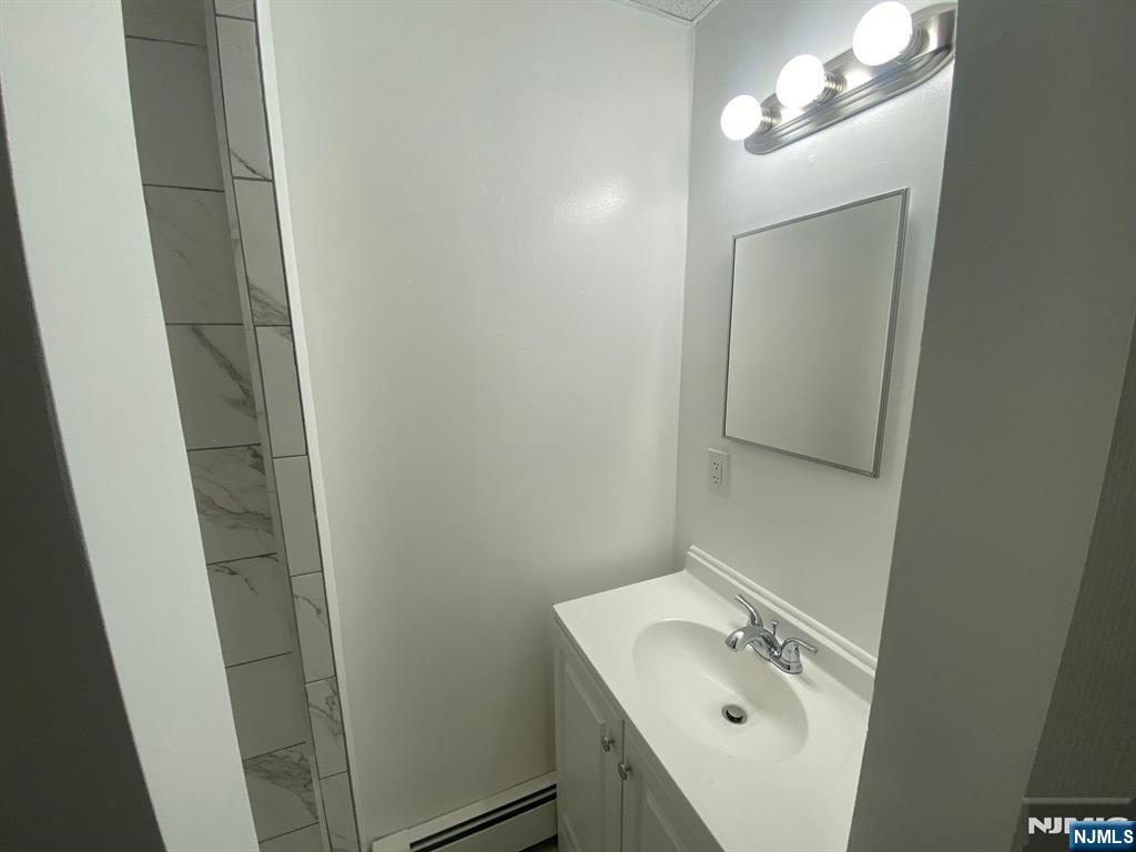 29 High Street, Unit 1R West Orange, NJ 07052 - Photo 16 of 19 a bathroom with a sink and mirror