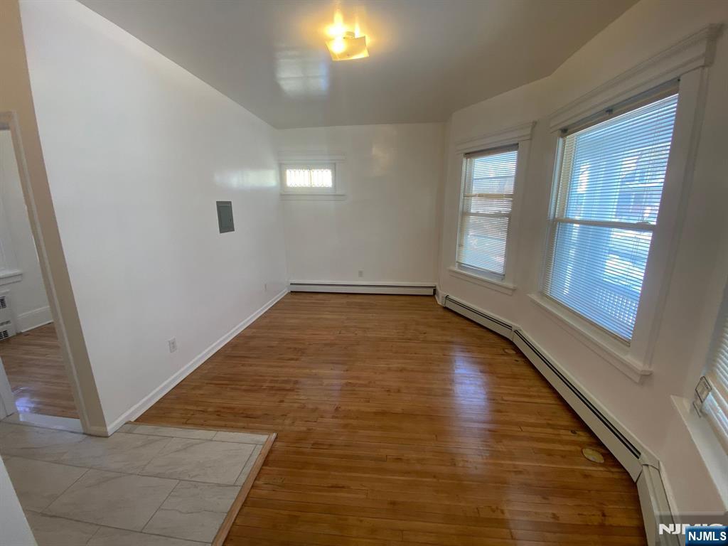29 High Street, Unit 1R West Orange, NJ 07052 - Photo 8 of 19 an empty room with wooden floor and windows