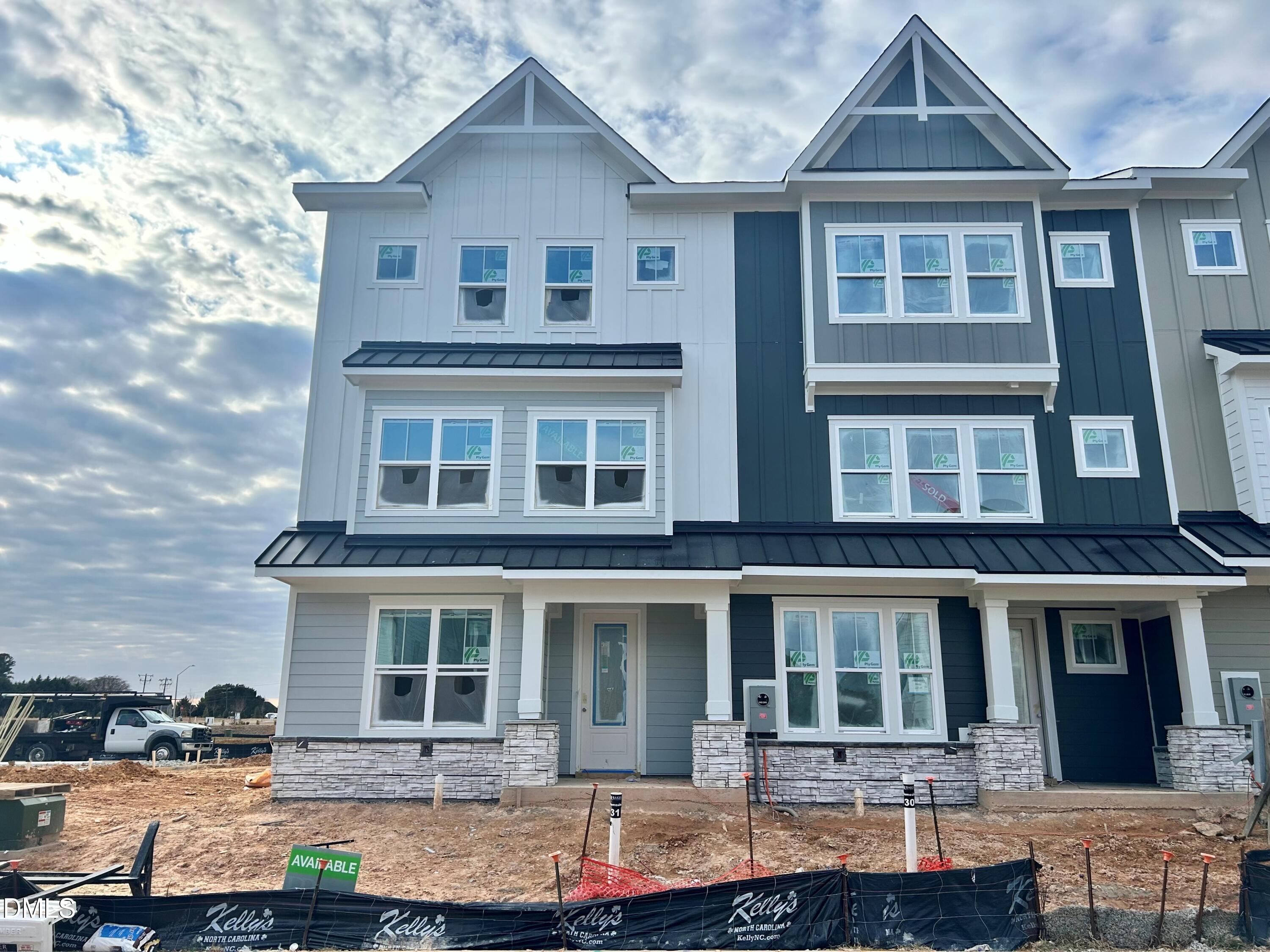 a front view of a house with yard and seating