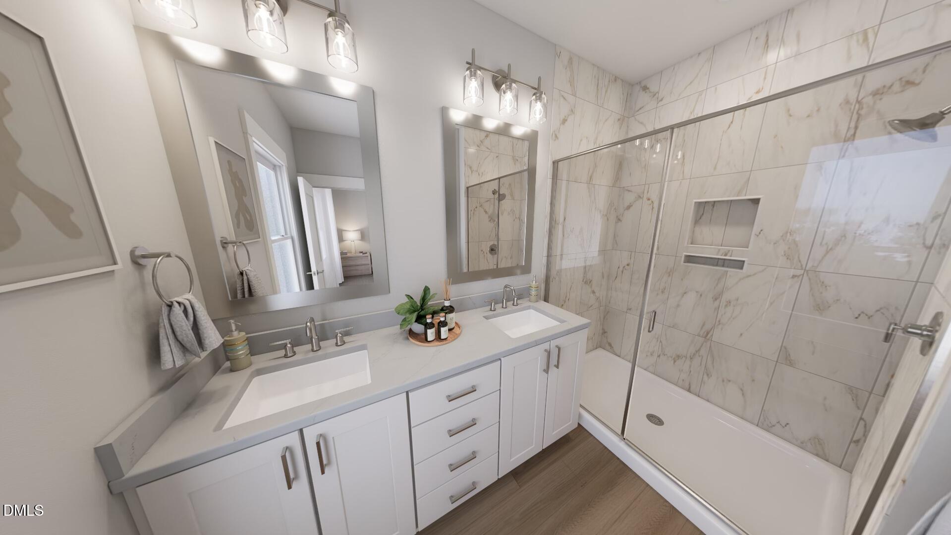 2411 Adrift Road Fuquay-Varina, NC 27526 - Photo 15 of 37 a bathroom with a double vanity sink a toilet a mirror and shower