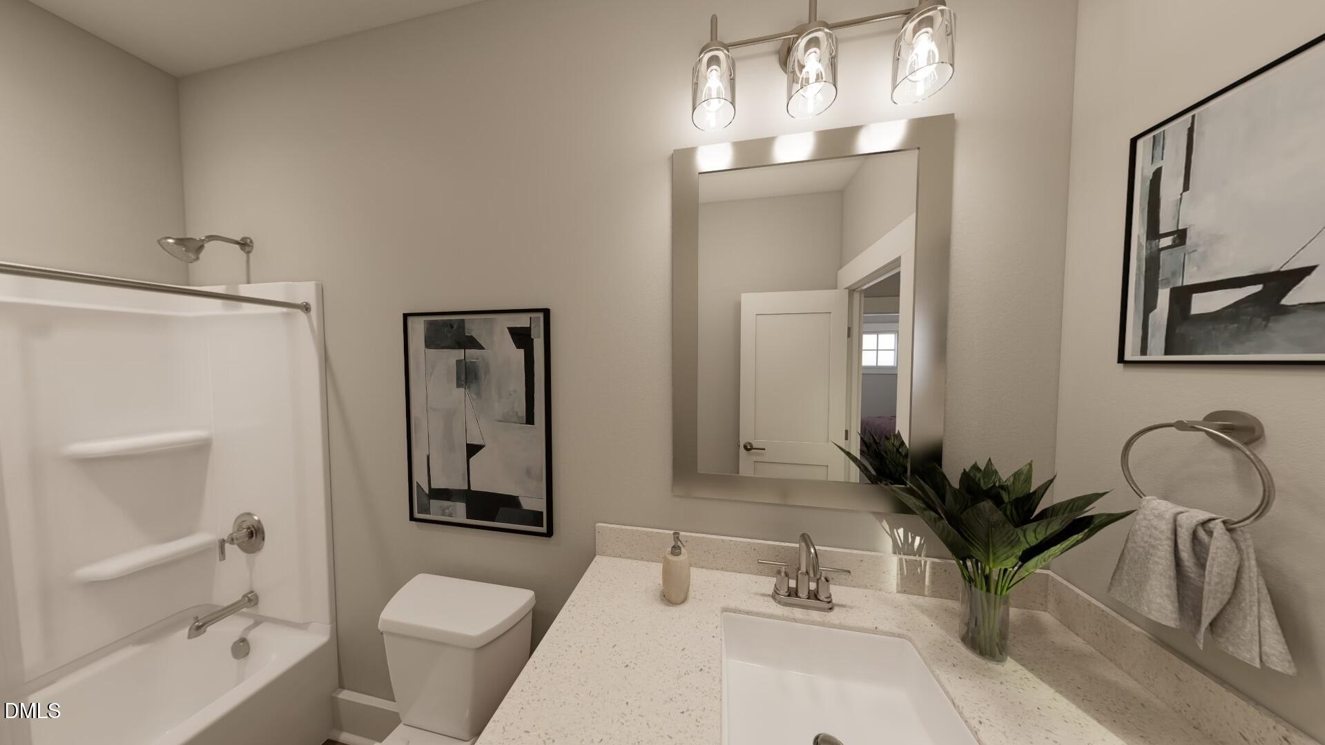 2411 Adrift Road Fuquay-Varina, NC 27526 - Photo 21 of 37 a bathroom with a sink a toilet and shower