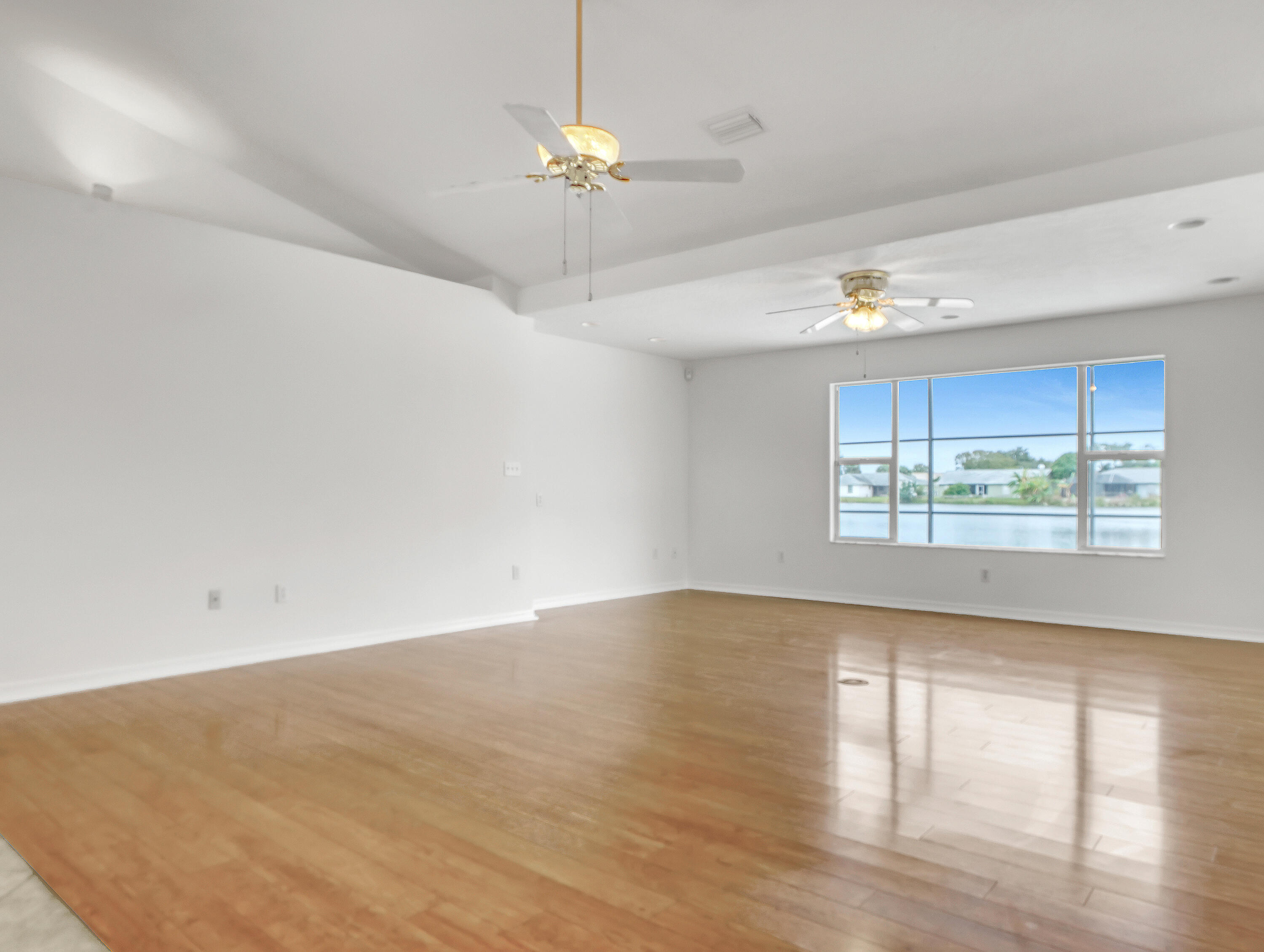 920 Turtle Pond Way Melbourne, FL 32940 - Photo 13 of 53 a view of an empty room with wooden floor and a window