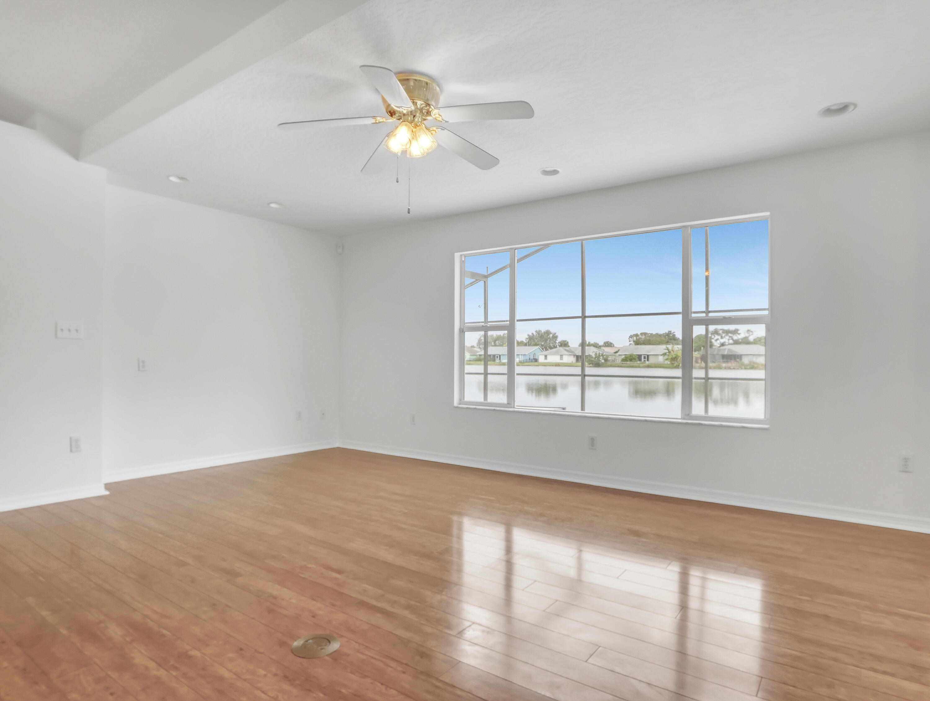 920 Turtle Pond Way Melbourne, FL 32940 - Photo 14 of 53 a view of an empty room with wooden floor and a window