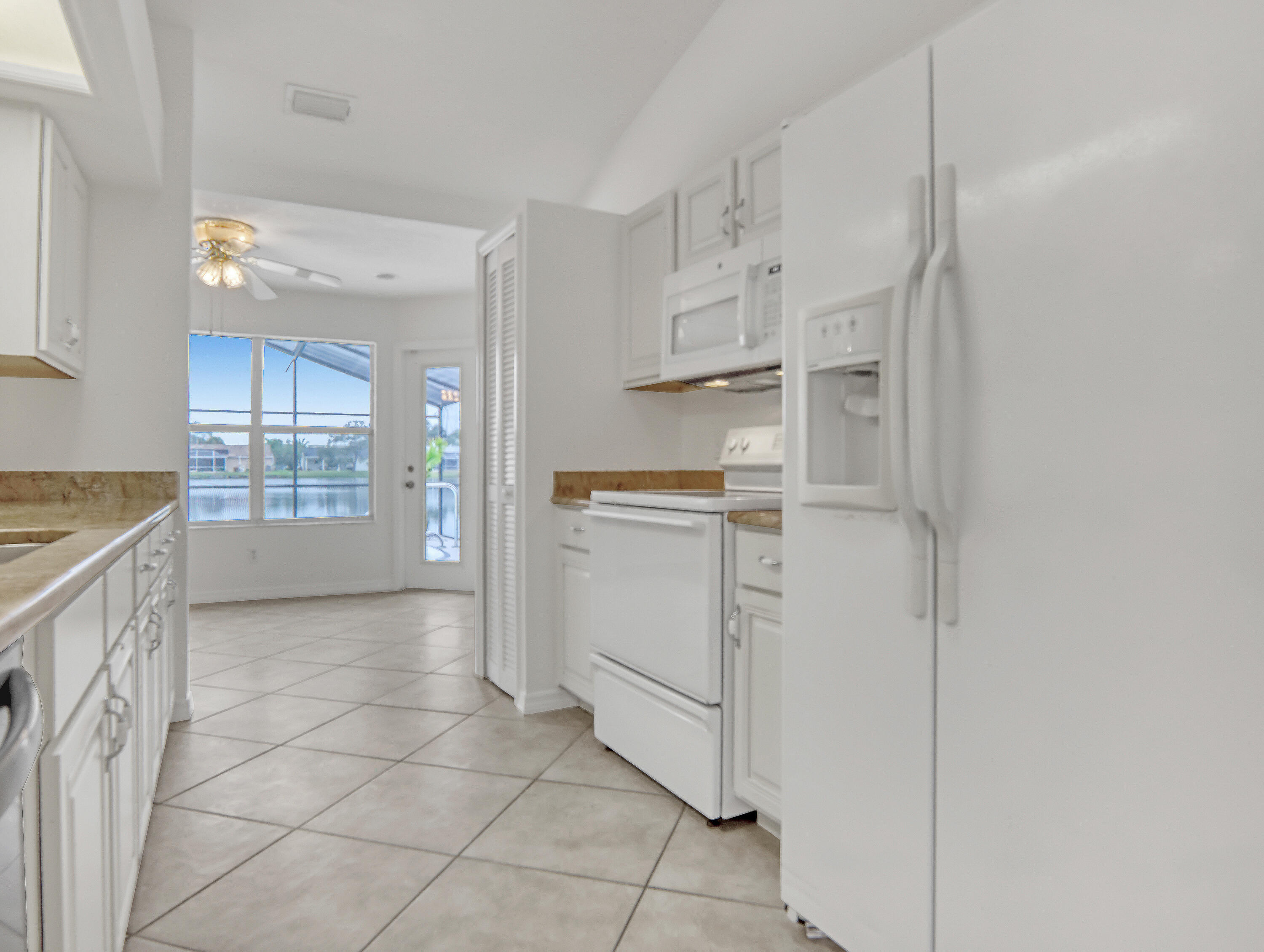 920 Turtle Pond Way Melbourne, FL 32940 - Photo 17 of 53 a kitchen with white cabinets and white appliances