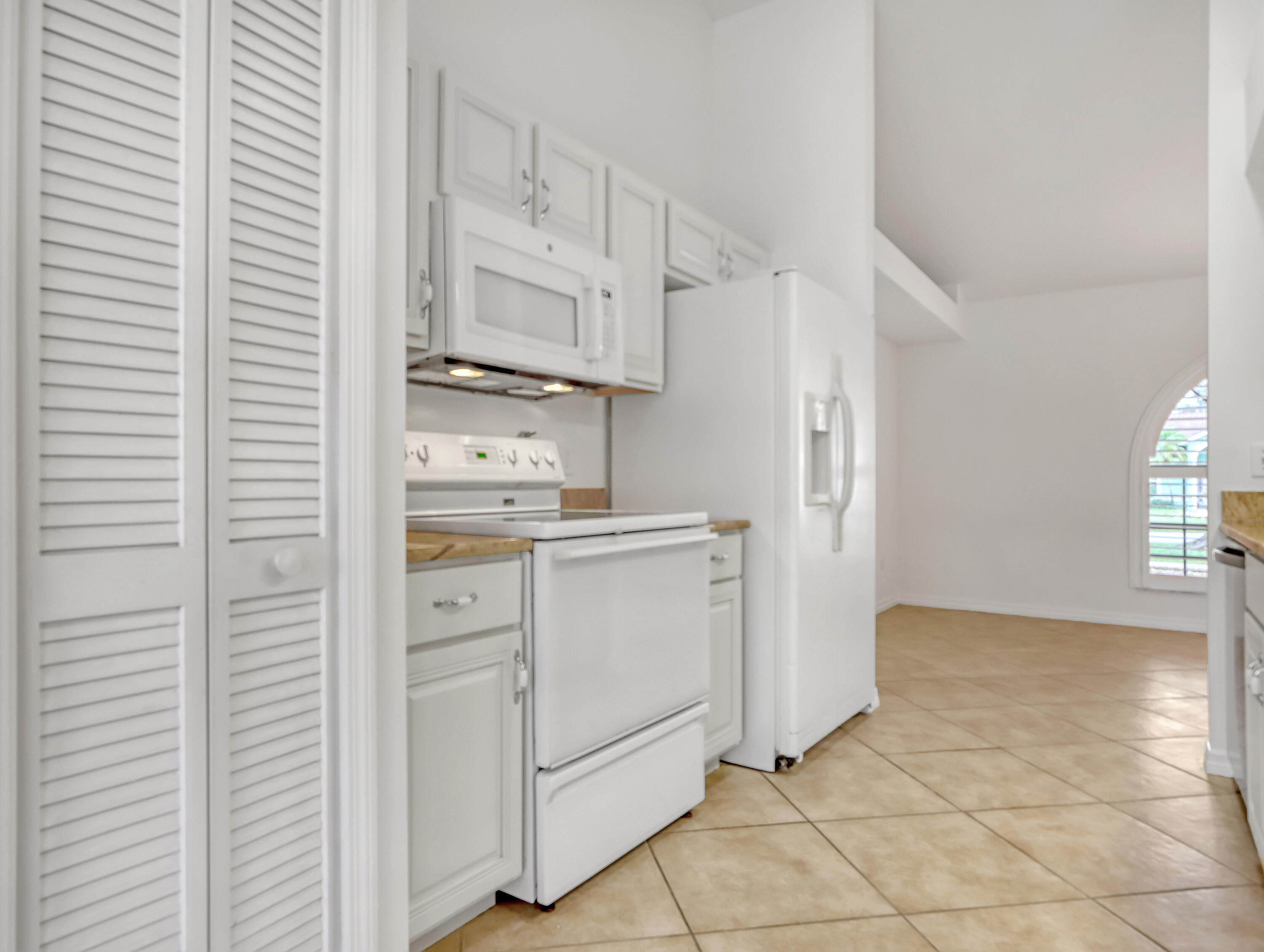 920 Turtle Pond Way Melbourne, FL 32940 - Photo 19 of 53 a kitchen with white cabinets and white appliances