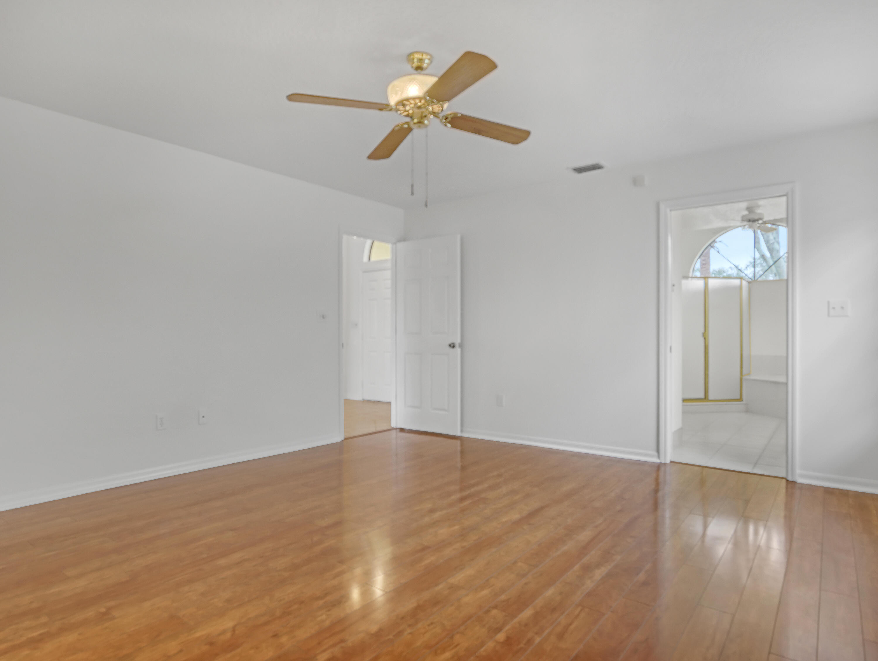 920 Turtle Pond Way Melbourne, FL 32940 - Photo 27 of 53 an empty room with wooden floor and ceiling fan