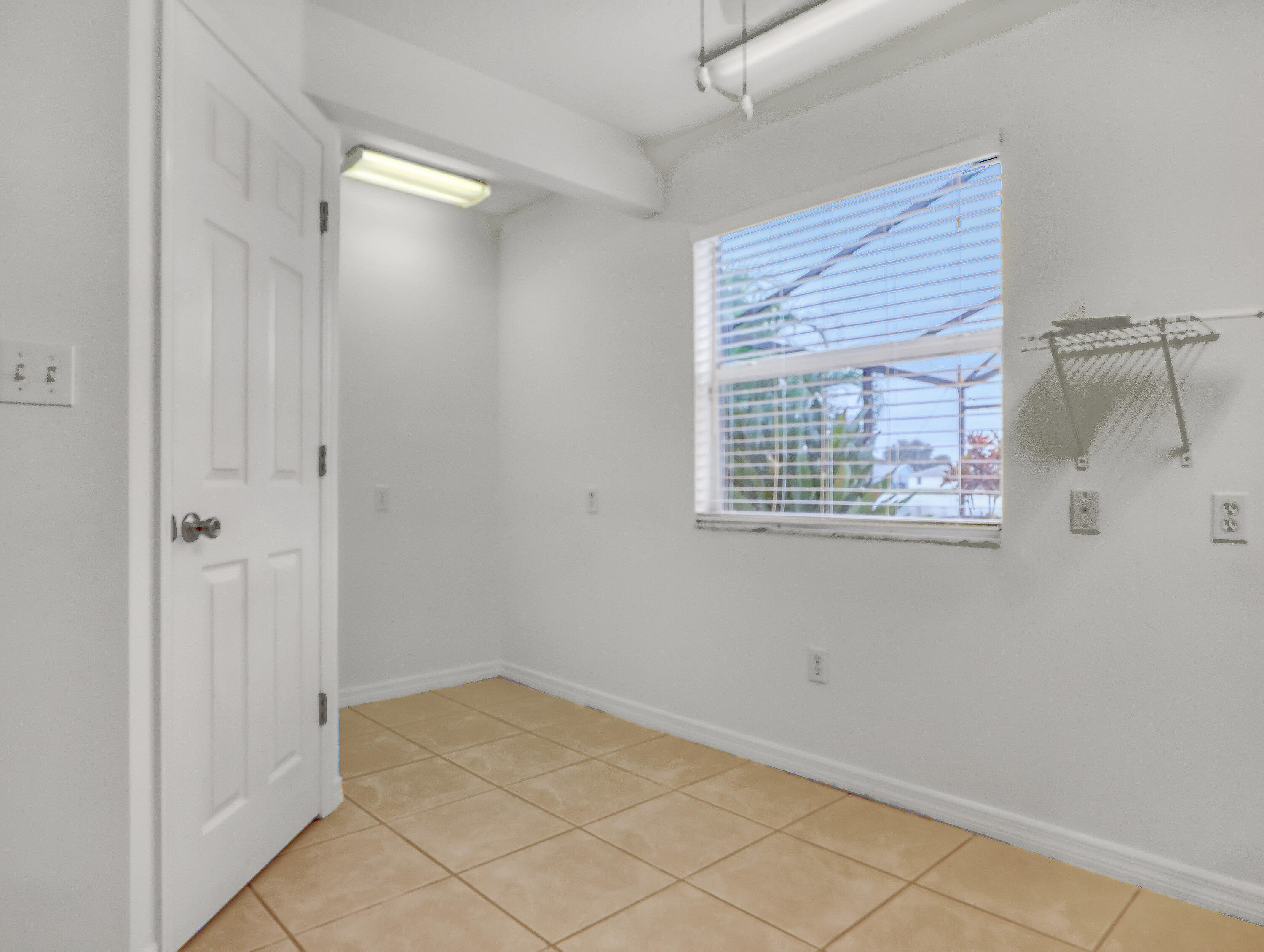920 Turtle Pond Way Melbourne, FL 32940 - Photo 29 of 53 a view of an empty room with wooden floor and a window