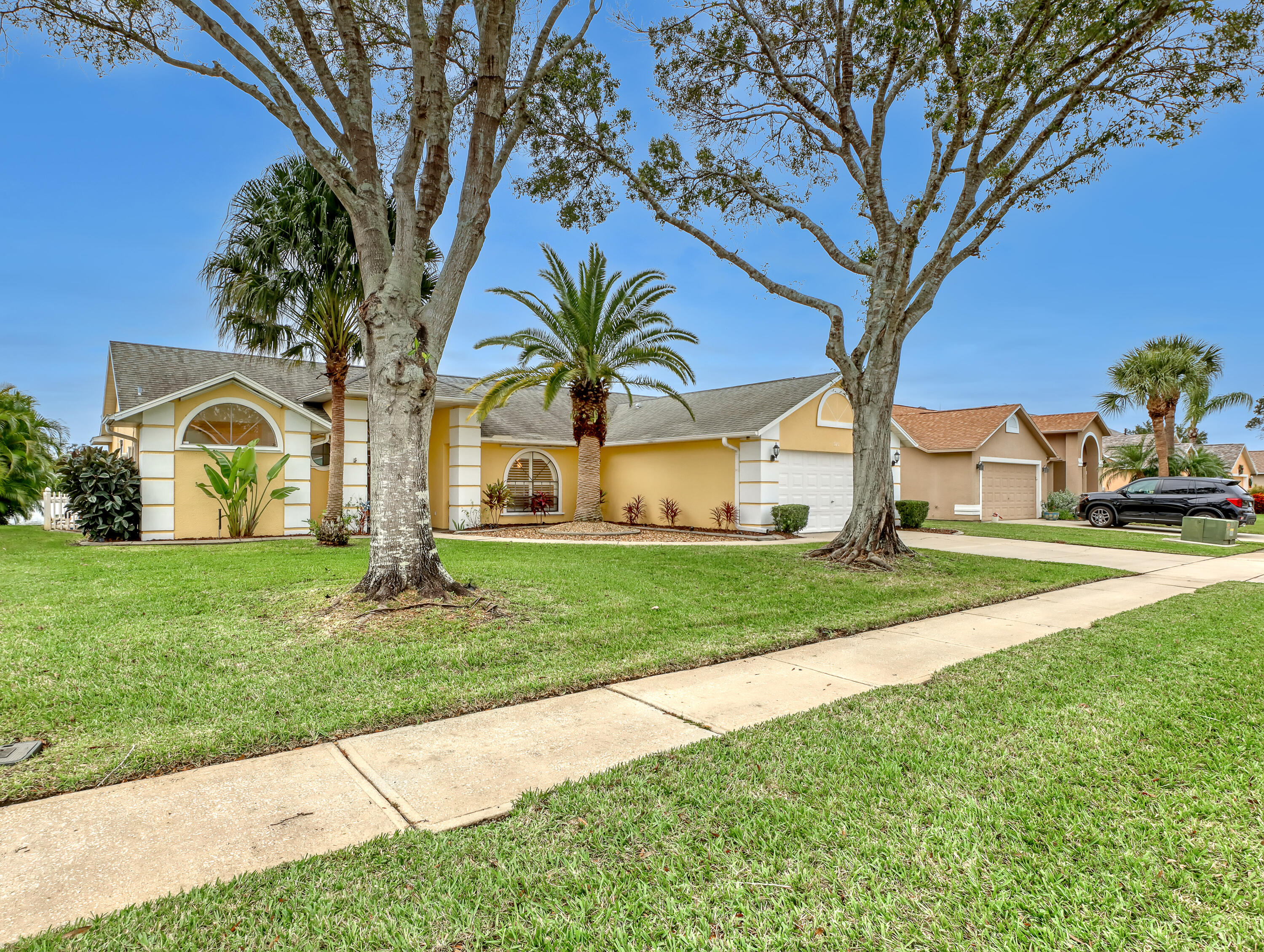 920 Turtle Pond Way Melbourne, FL 32940 - Photo 5 of 53 a view of a white house with a big yard and large trees