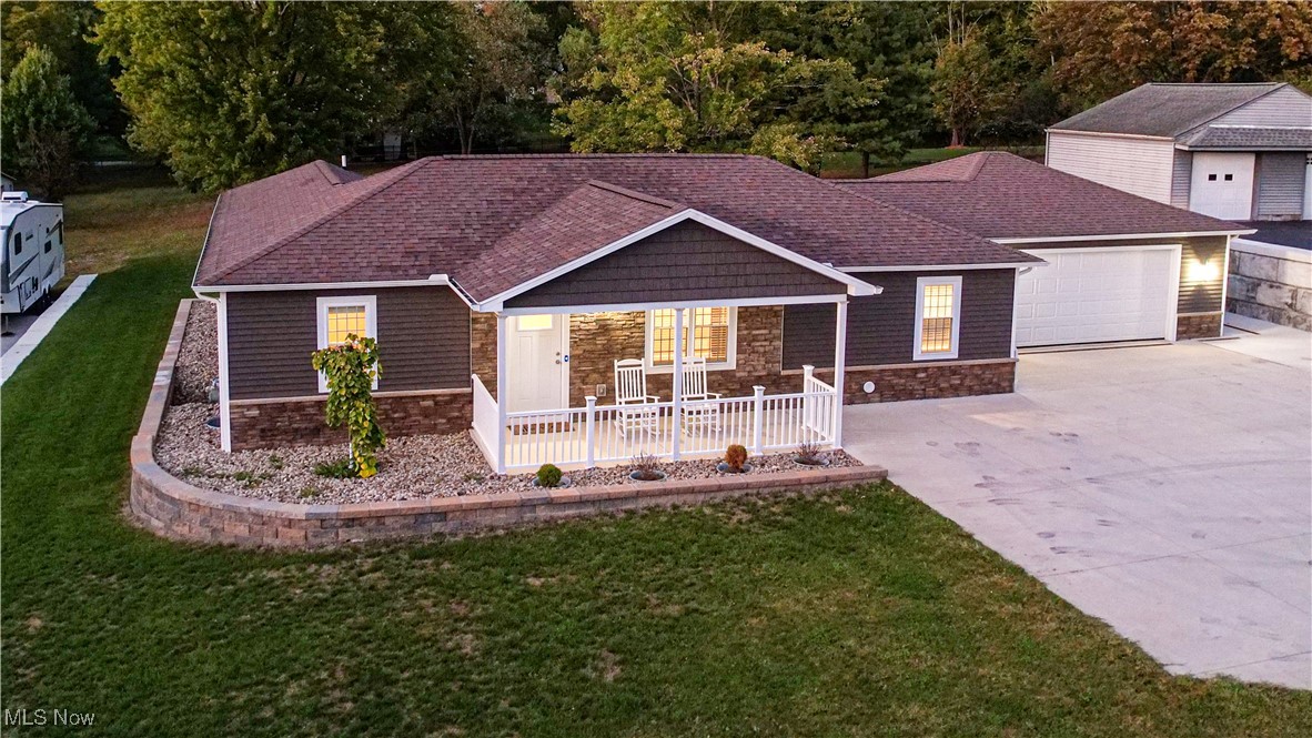 6264 Herbert Road Canfield, OH 44406 - Photo 42 of 47 Ranch-style house with stone siding, driveway, a shingled roof, and a front yard