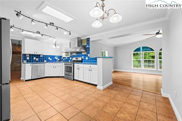 a kitchen with stainless steel appliances granite countertop a sink and cabinets