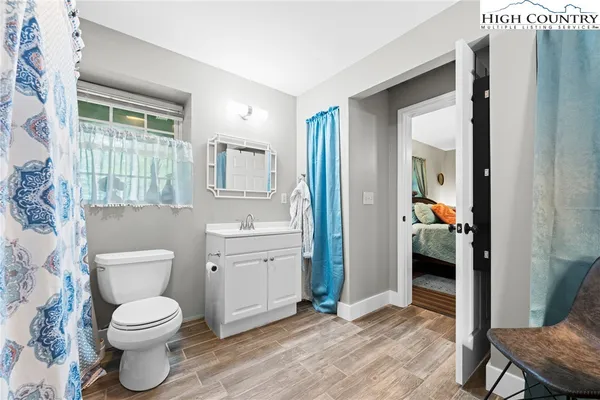 a bed room with a bed and a chair