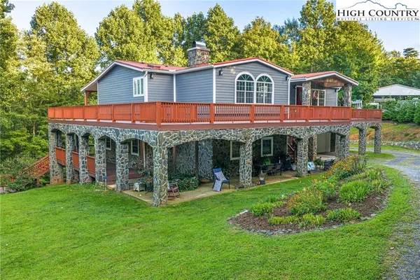 a view of a house with garden and porch