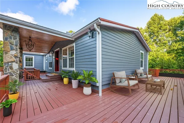 a view of a house with deck and wooden floor