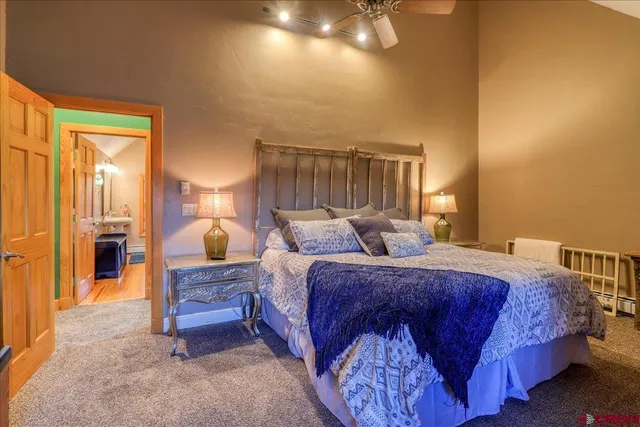 a spacious bedroom with two beds and a chandelier