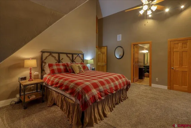 a bedroom with a bed and ceiling fan
