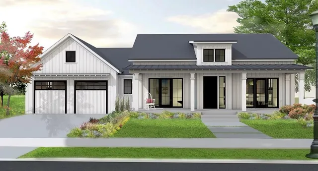 a front view of a house with a yard and potted plants