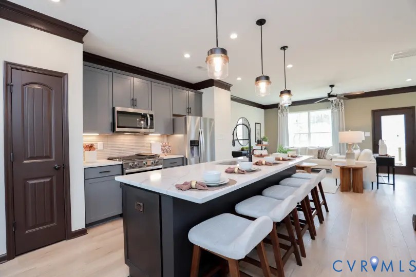 16313 Alexandria Court Chesterfield, VA 23832 - Photo 3 of 13 a kitchen with stainless steel appliances a stove a sink a dining table and chairs