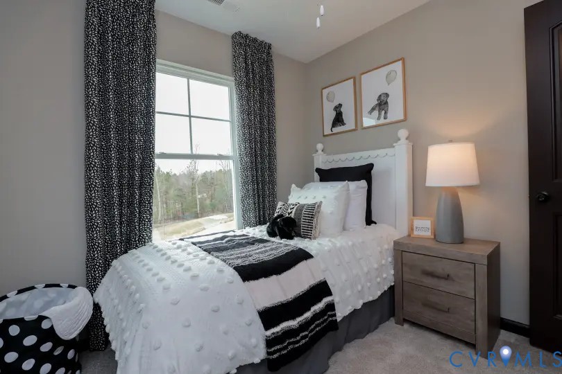 16313 Alexandria Court Chesterfield, VA 23832 - Photo 8 of 13 a bedroom with a bed and a night stand next to a window