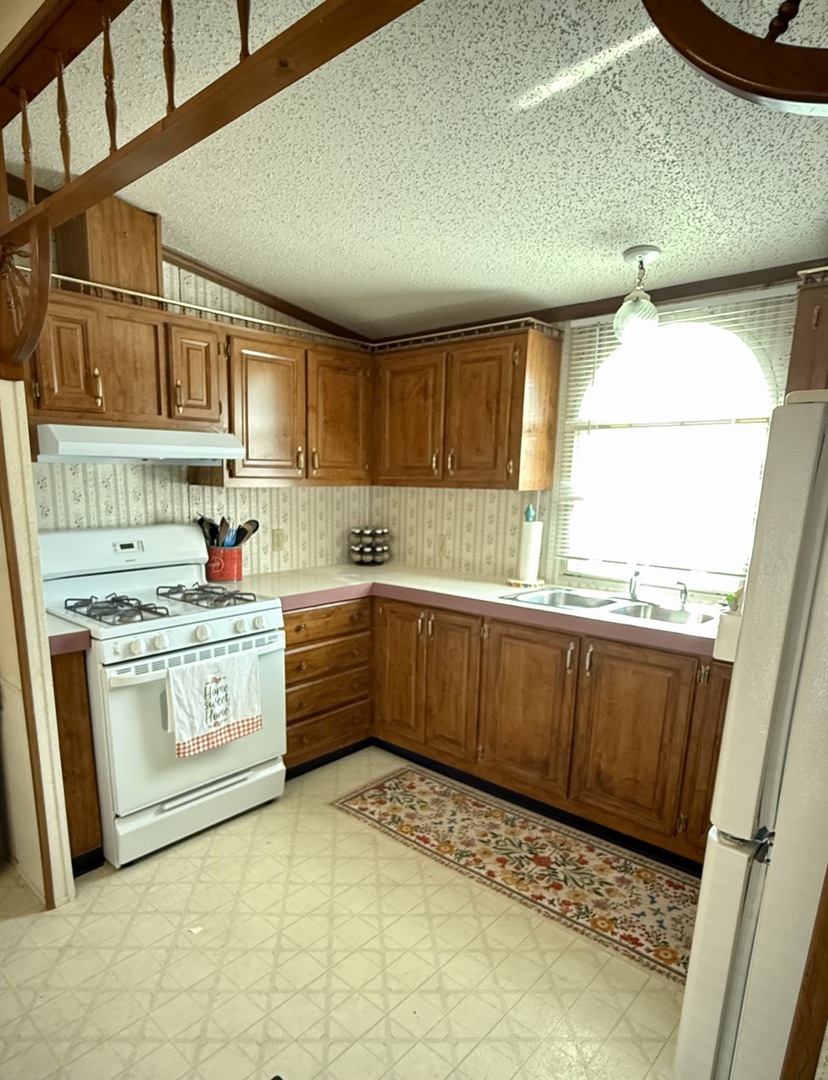 23 Walnut Street Minooka, IL 60447 - Photo 6 of 17 a kitchen with stainless steel appliances granite countertop a sink window and cabinets
