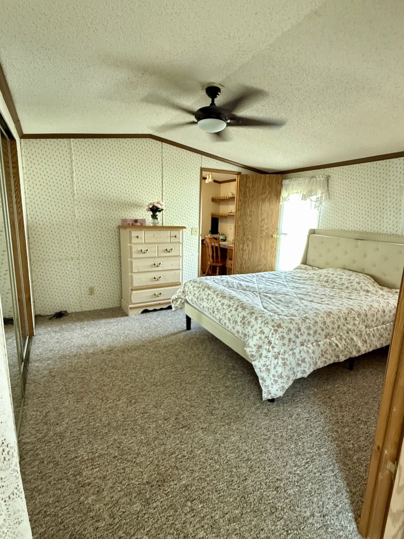 23 Walnut Street Minooka, IL 60447 - Photo 10 of 17 a bedroom with a bed and a walk in closet