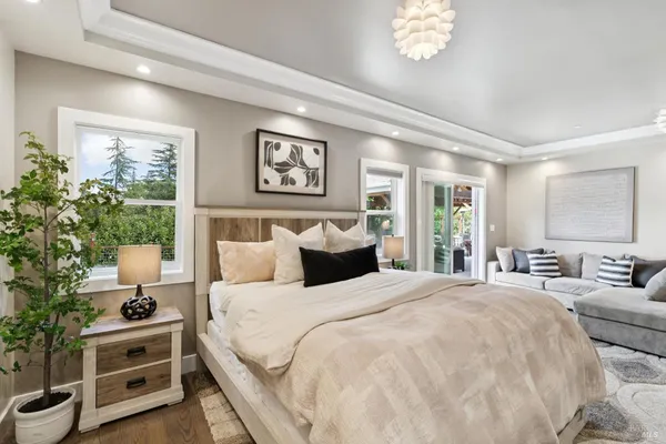 a kitchen with stainless steel appliances granite countertop a stove a refrigerator a kitchen island a table and chairs