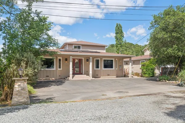 a front view of a house with a garden