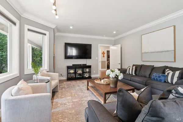 a living room with furniture fireplace and flat screen tv