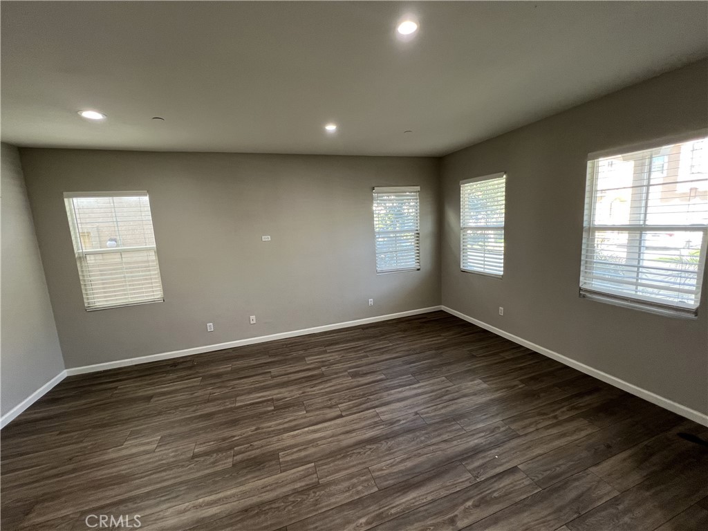 1779 Edmon Way Riverside, CA 92501 - Photo 2 of 10 a view of an empty room with wooden floor and window