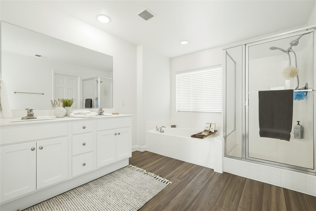 1779 Edmon Way Riverside, CA 92501 - Photo 9 of 10 a spacious bathroom with a double vanity sink a mirror and shower