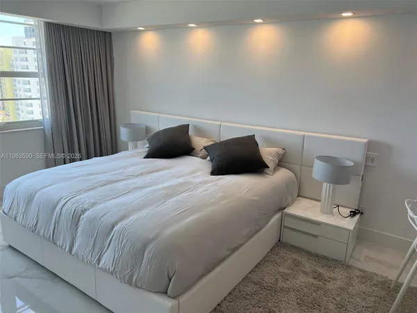 a bedroom with a bed and a television