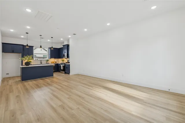 a view of kitchen and kitchen with wooden floor