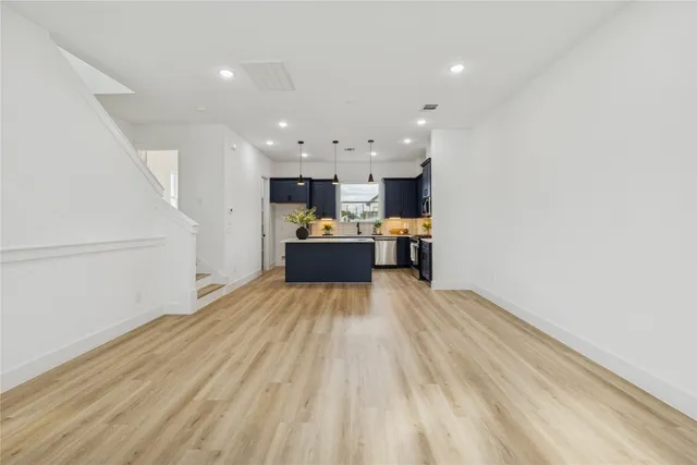 a view of kitchen and hall with wooden floor