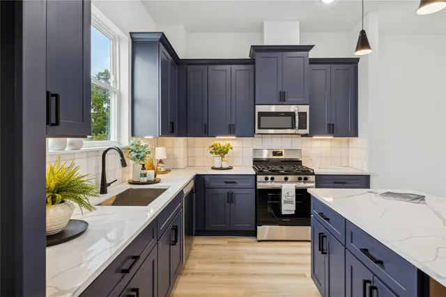 a kitchen with granite countertop wooden cabinets and a stove top oven