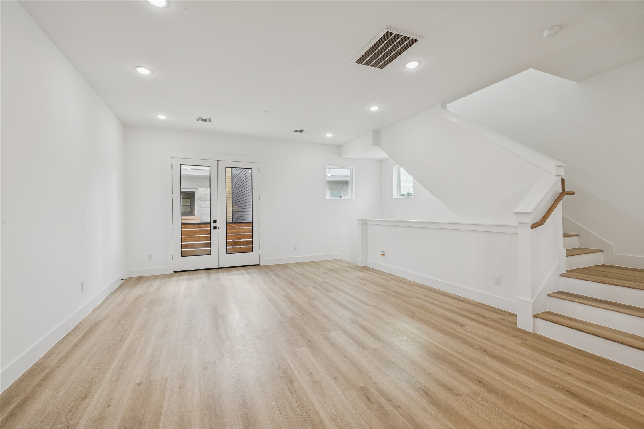 113 Milby Street Houston, TX 77003 - Photo 17 of 38 a view of an empty room with wooden floor and a ceiling fan