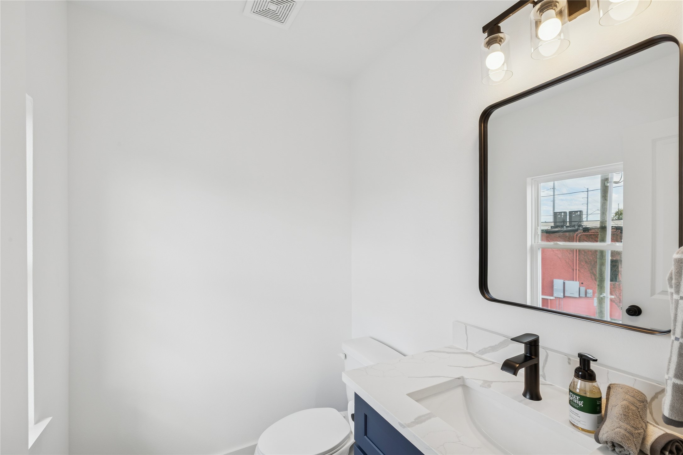 113 Milby Street Houston, TX 77003 - Photo 19 of 38 a bathroom with a sink mirror and toilet