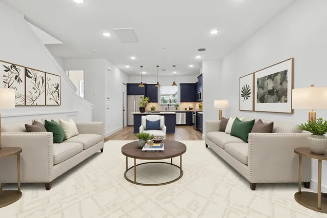 a living room with furniture kitchen view and a table