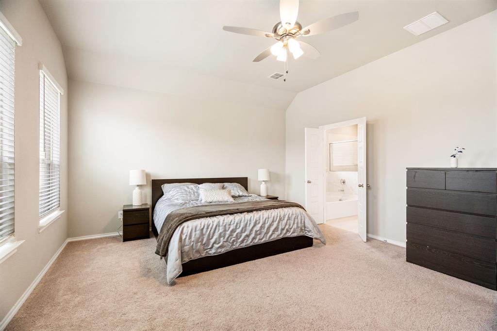 321 Pasture Drive Midlothian, TX 76065 - Photo 16 of 40 a spacious bedroom with a bed and a chandelier