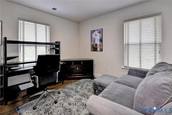 a kitchen with stainless steel appliances granite countertop a refrigerator a sink a stove a dining table and chairs
