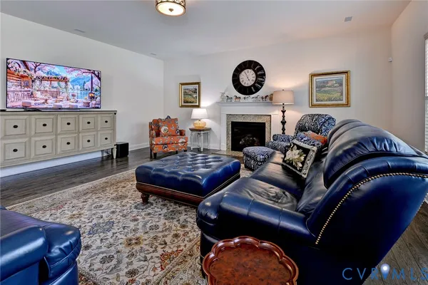 a living room with furniture windows and wooden floor