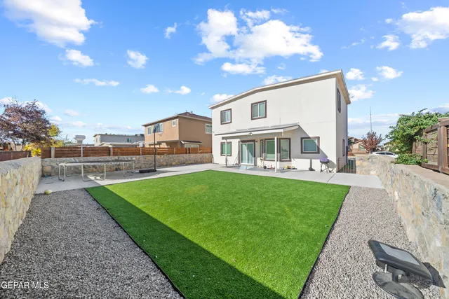 a view of a house with backyard porch and sitting area
