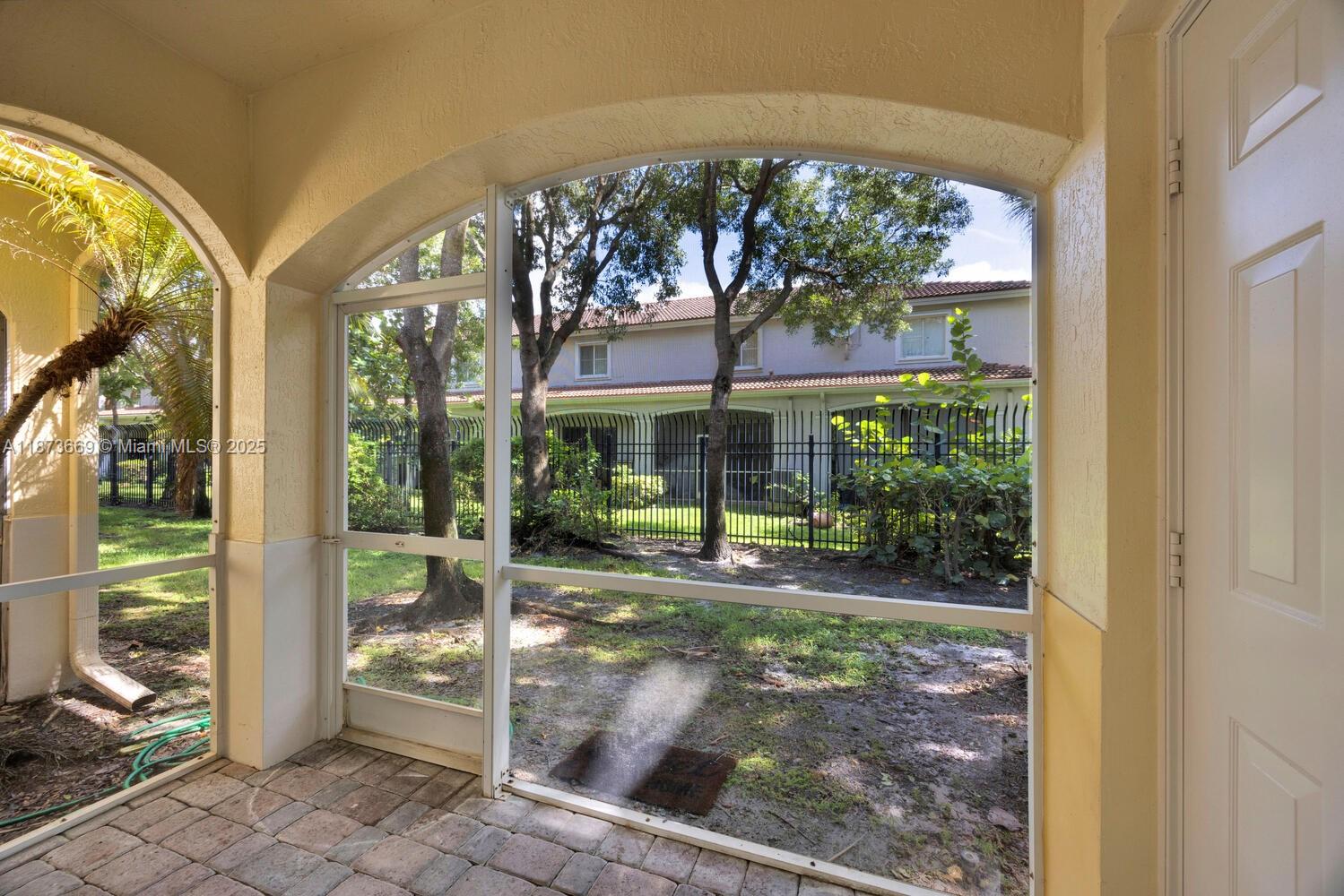 2641 Southwest 83rd Terrace, Unit 104 Miramar, FL 33025 - Photo 16 of 30 a view of patio with a table and chairs under an umbrella