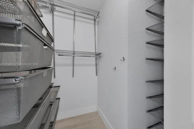 a view of storage and utility room with racks on the wall