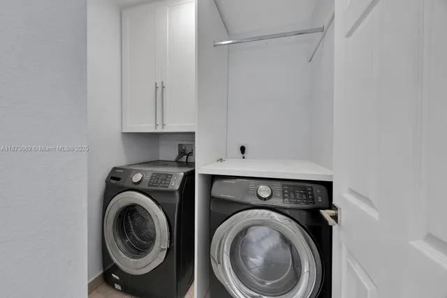 a view of storage and utility room with washer and dryer