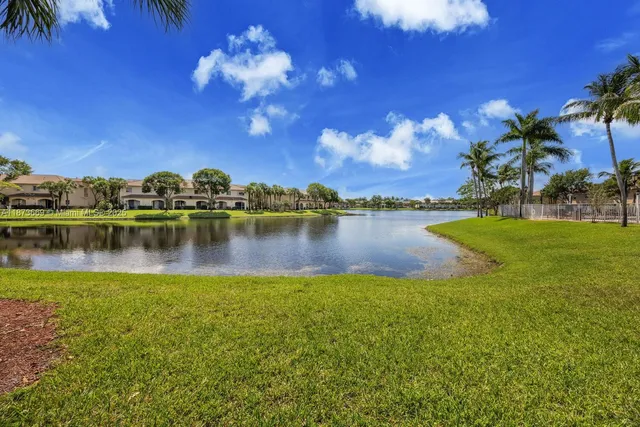 a view of a lake with houses in the back